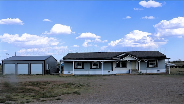 ranch-style home with an outdoor structure, a porch, and a garage