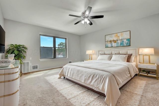 bedroom with baseboards, visible vents, ceiling fan, and light colored carpet