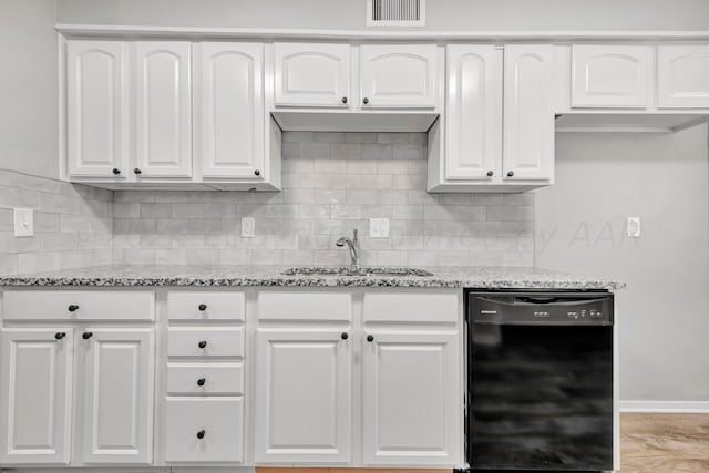 kitchen with black dishwasher, visible vents, and white cabinets