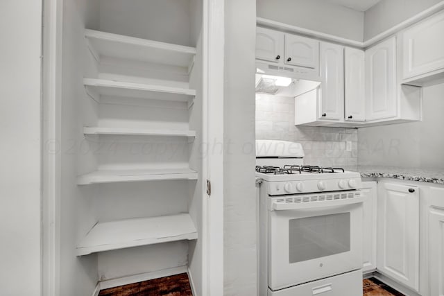 kitchen with open shelves, backsplash, white cabinets, white range with gas stovetop, and under cabinet range hood