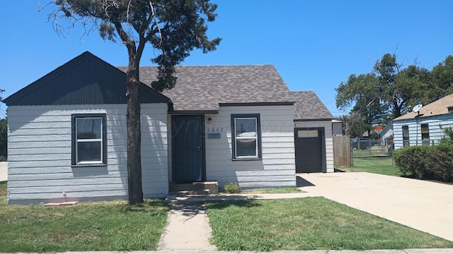 bungalow-style home featuring a garage and a front yard