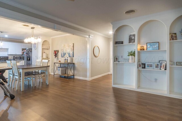 3102 S Bivins St, Amarillo, TX 79103 - dining room featuring built in shelves, wood finished floors, crown molding, and a chandelier