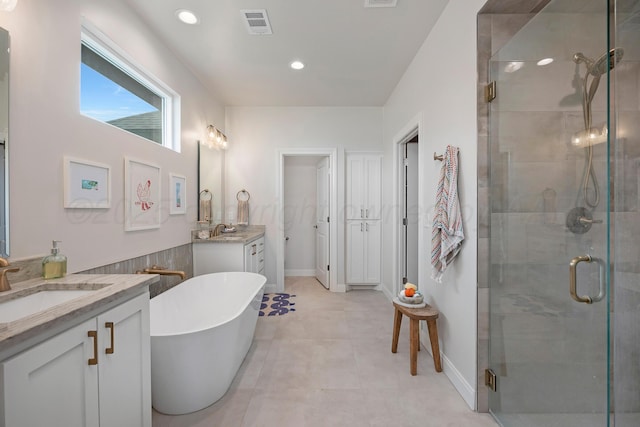 8100 Pensacola Ave, Amarillo, TX 79118 - bathroom featuring vanity, a shower stall, a freestanding tub, tile patterned flooring, and recessed lighting