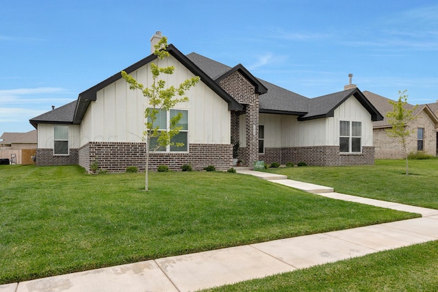 8100 Pensacola Ave, Amarillo, TX 79118 - view of front of house featuring brick siding, board and batten siding, a front yard, and a shingled roof