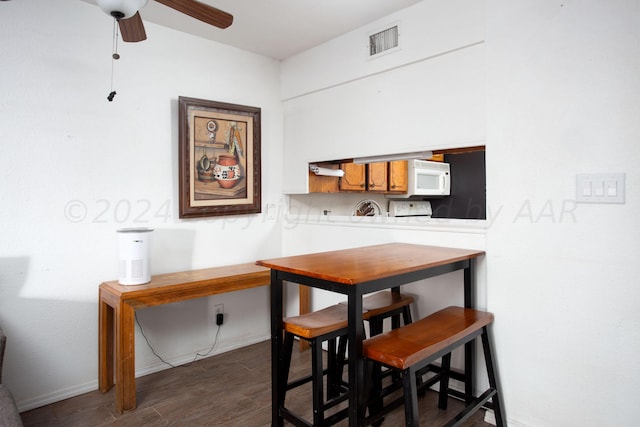 dining area with dark hardwood / wood-style flooring and ceiling fan