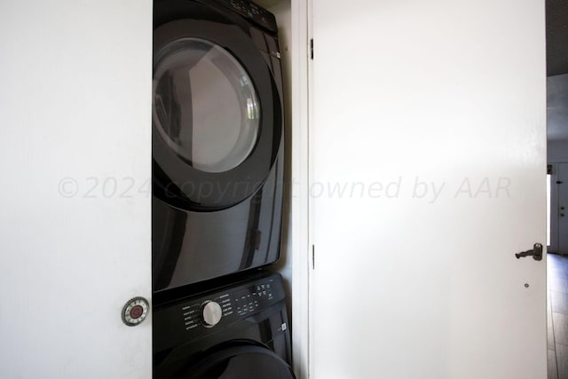 laundry area featuring stacked washing maching and dryer