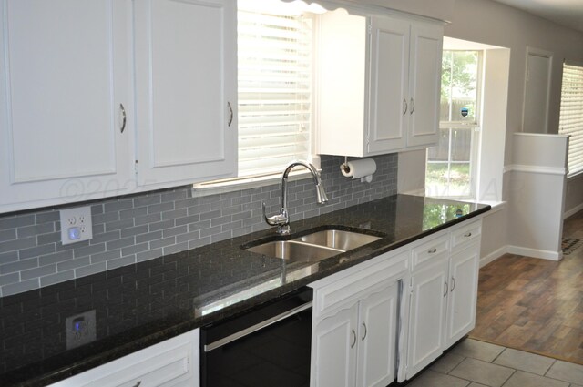 3411 Royal Rd, Amarillo, TX 79109 - kitchen featuring black dishwasher, white cabinetry, backsplash, and dark stone countertops