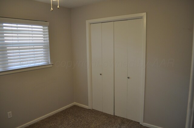 3411 Royal Rd, Amarillo, TX 79109 - unfurnished bedroom featuring dark carpet and a closet
