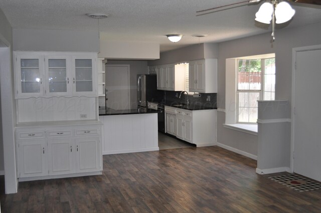 3411 Royal Rd, Amarillo, TX 79109 - kitchen featuring a ceiling fan, dark wood-style flooring, decorative backsplash, white cabinets, and freestanding refrigerator