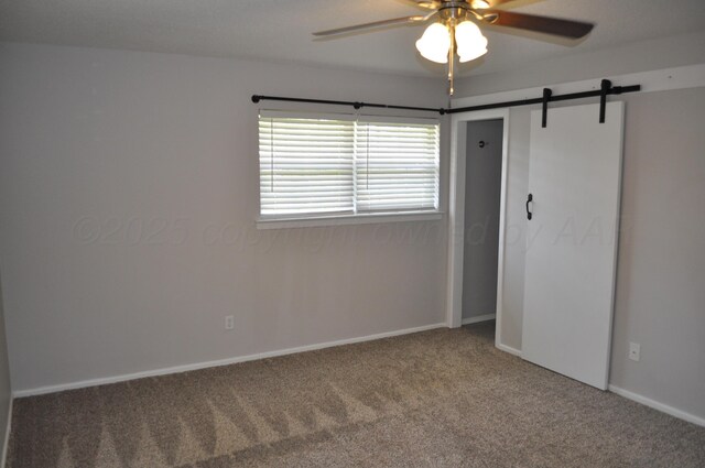 3411 Royal Rd, Amarillo, TX 79109 - unfurnished bedroom with carpet flooring, a barn door, a ceiling fan, and a closet