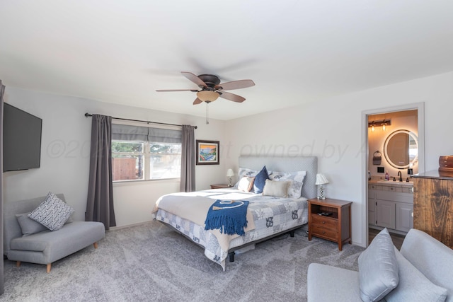 carpeted bedroom with ceiling fan, connected bathroom, and sink