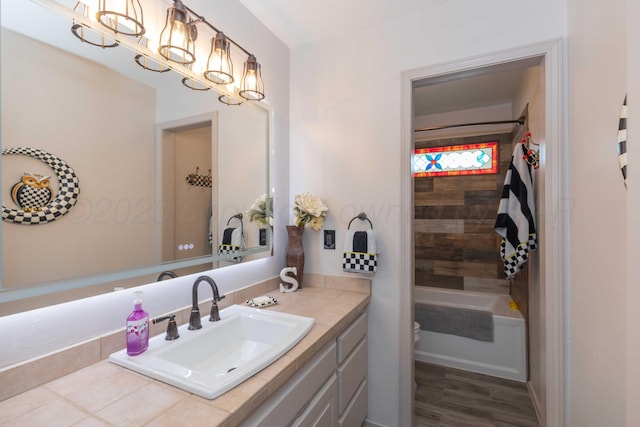 bathroom with shower / bathtub combination, a chandelier, vanity, and hardwood / wood-style flooring