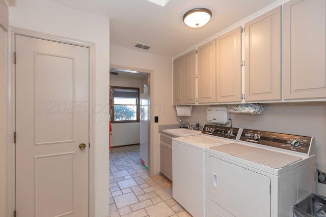 clothes washing area featuring cabinets, washer and clothes dryer, and sink