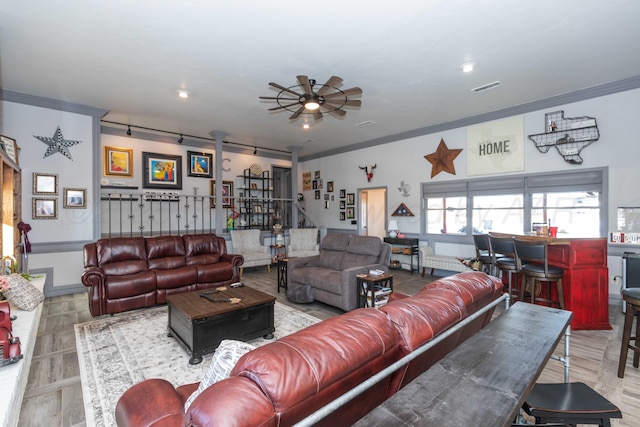 living room featuring ceiling fan and ornamental molding