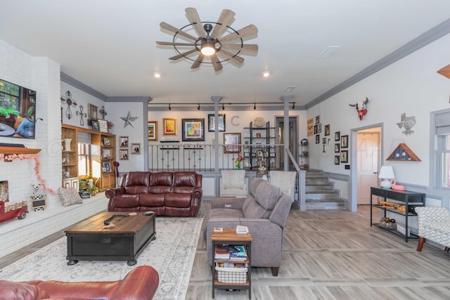 living room with ceiling fan and crown molding