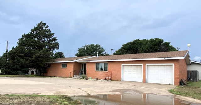 403 Purnell Ave, Stratford, TX 79084 - single story home featuring an attached garage, concrete driveway, and brick siding