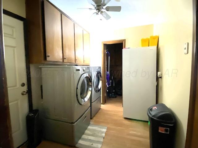 laundry area with washer and clothes dryer, light hardwood / wood-style floors, cabinets, and ceiling fan