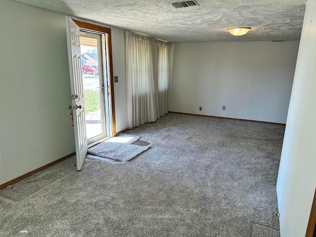 empty room featuring carpet floors and a textured ceiling