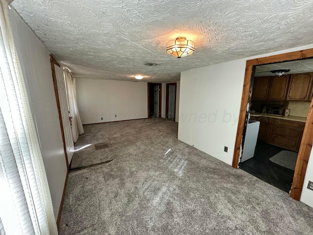 unfurnished bedroom with carpet floors and a textured ceiling