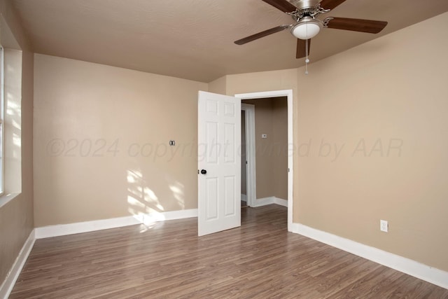 spare room with ceiling fan and hardwood / wood-style floors