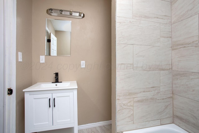 bathroom featuring a washtub and vanity