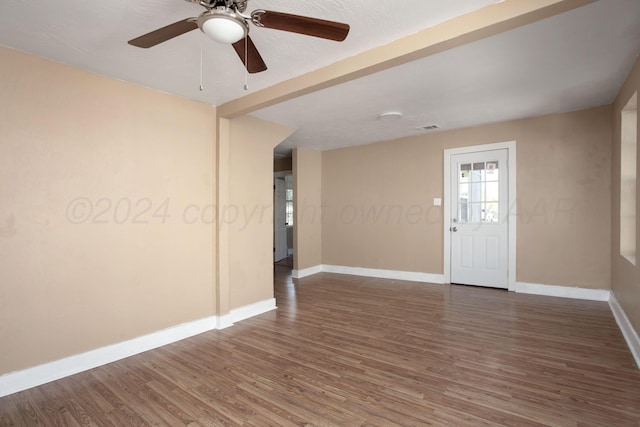 empty room featuring ceiling fan and dark hardwood / wood-style floors