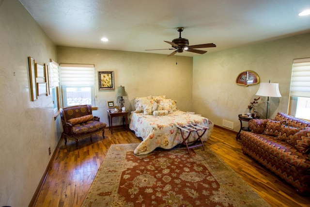 bedroom with dark wood-type flooring and ceiling fan