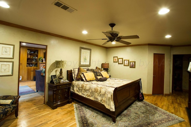 bedroom featuring ceiling fan, light hardwood / wood-style flooring, and crown molding