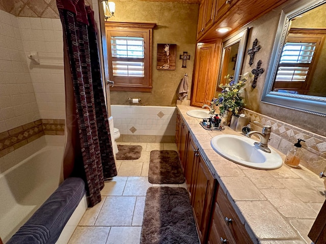 full bathroom with decorative backsplash, vanity, toilet, and shower / tub combo with curtain