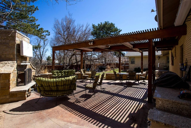 view of patio / terrace featuring a pergola and an outdoor stone fireplace