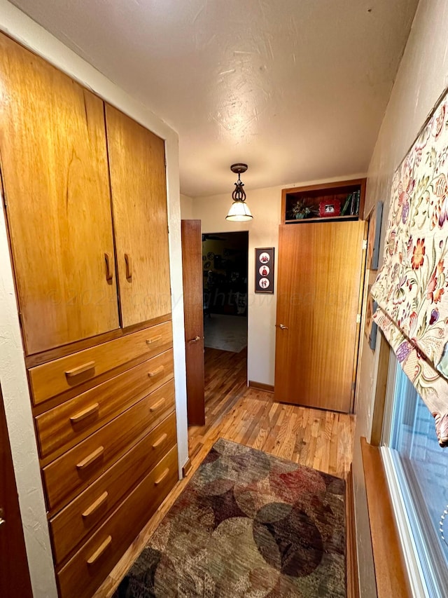 hall with light hardwood / wood-style floors