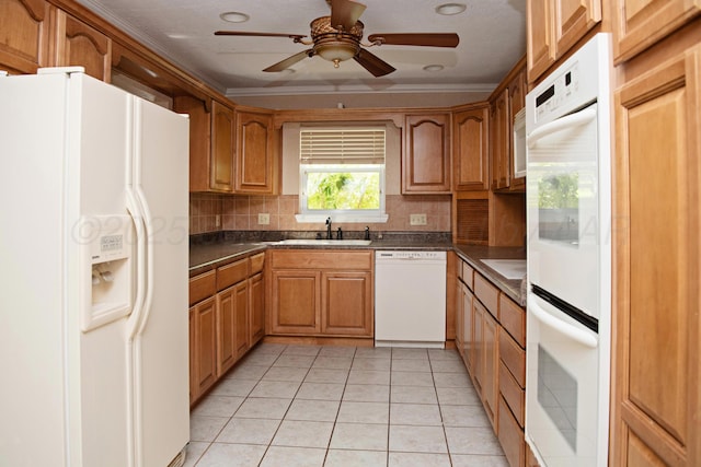 411 E 6th St, Hereford, TX 79045 - kitchen with white appliances, a sink, dark countertops, tasteful backsplash, and a ceiling fan