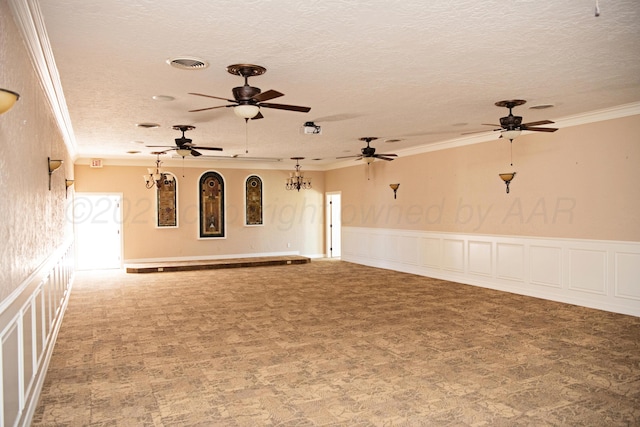 411 E 6th St, Hereford, TX 79045 - spare room featuring ornamental molding, a textured ceiling, carpet, a ceiling fan, and wainscoting