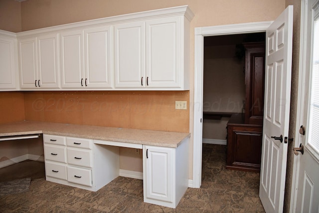 411 E 6th St, Hereford, TX 79045 - unfurnished office featuring built in desk and baseboards