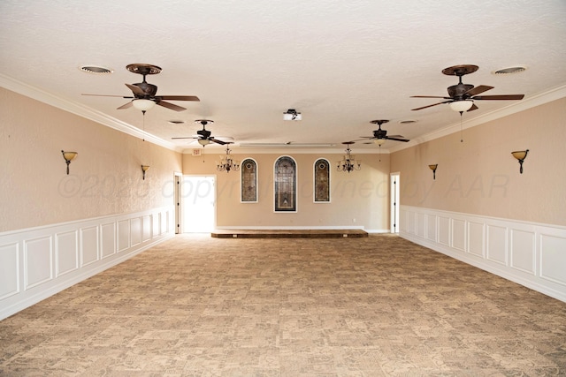 411 E 6th St, Hereford, TX 79045 - spare room with ceiling fan, crown molding, a decorative wall, a textured ceiling, and wainscoting