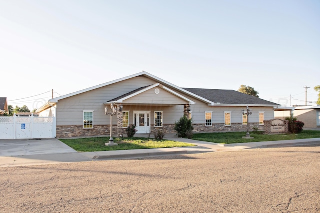 411 E 6th St, Hereford, TX 79045 - view of front facade featuring stone siding and a gate