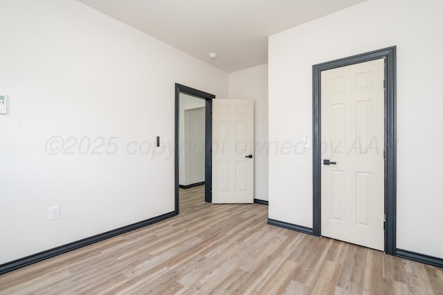 unfurnished bedroom featuring light wood-style flooring