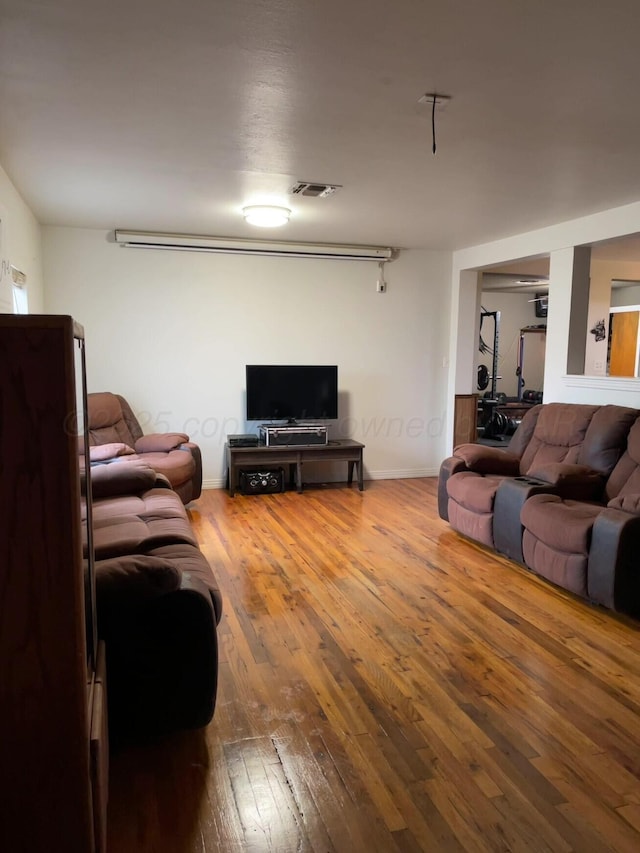 living room with wood-type flooring and visible vents
