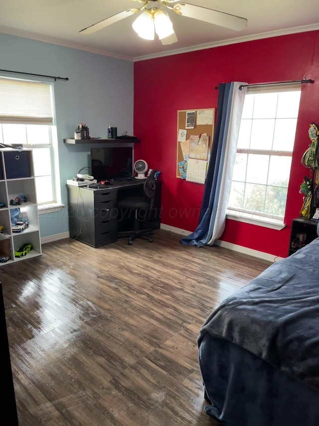 bedroom with baseboards, ornamental molding, a ceiling fan, and wood finished floors