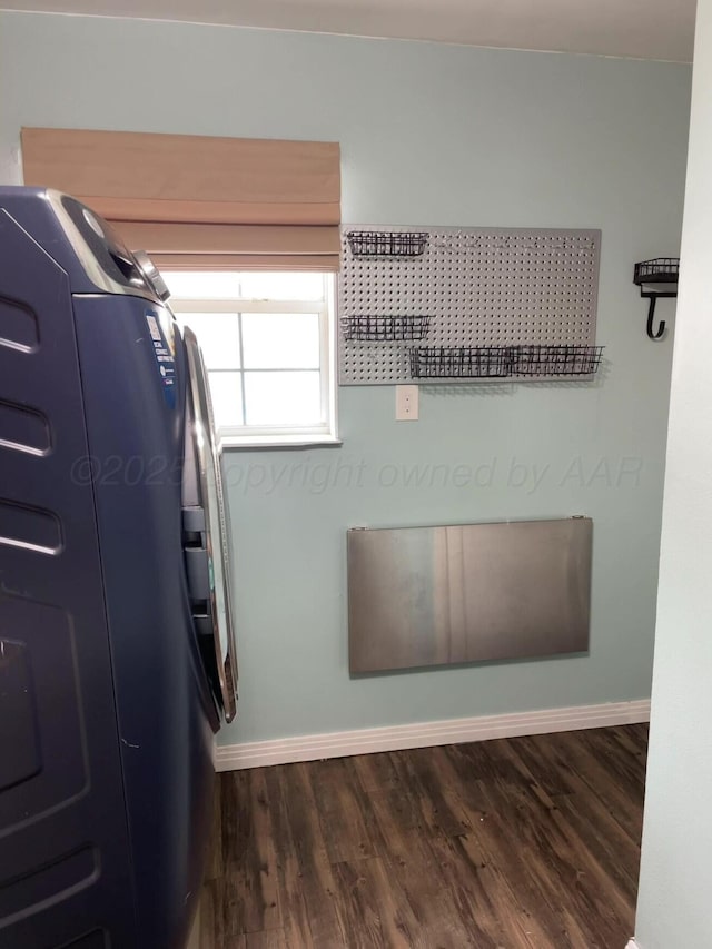 interior space featuring laundry area, baseboards, and dark wood-style floors