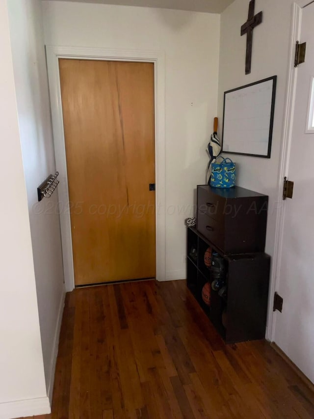 corridor featuring wood finished floors