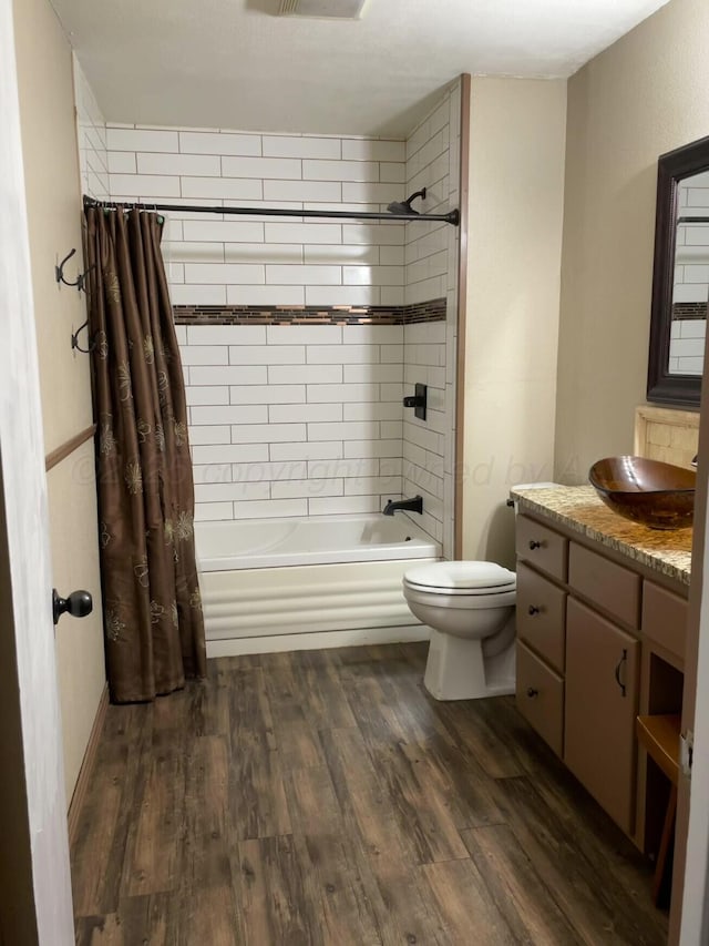 full bathroom featuring shower / tub combo, toilet, vanity, and wood finished floors