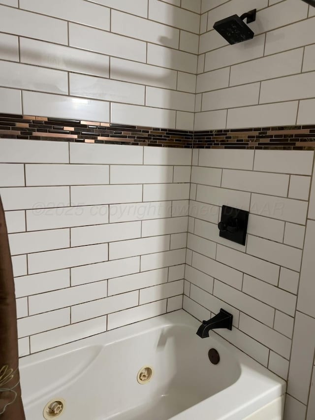 bathroom with shower / bath combo with shower curtain
