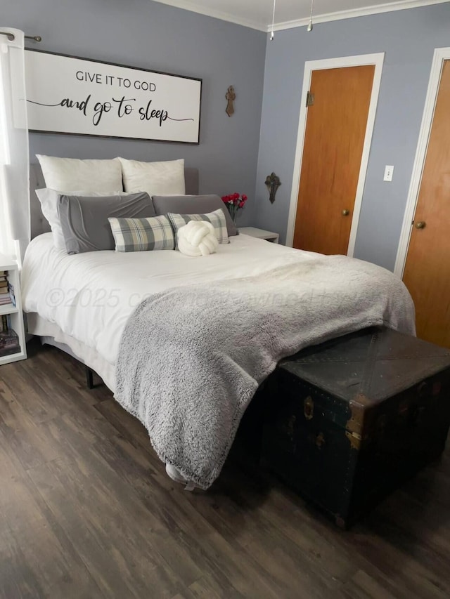 bedroom featuring crown molding and wood finished floors