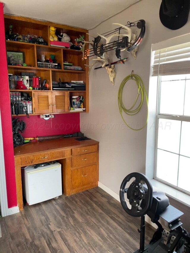 interior space featuring dark wood-style flooring and baseboards