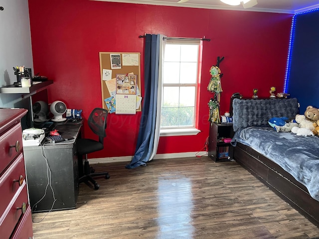 bedroom featuring baseboards and wood finished floors