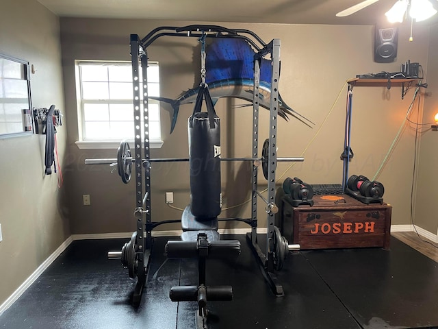 exercise area featuring ceiling fan and baseboards