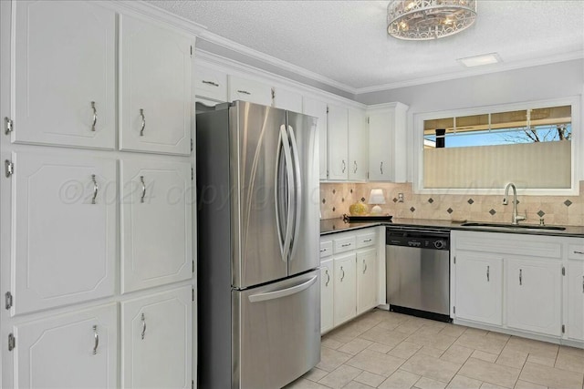 kitchen featuring sink, crown molding, decorative backsplash, white cabinets, and appliances with stainless steel finishes