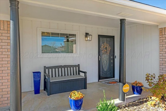 view of exterior entry featuring covered porch