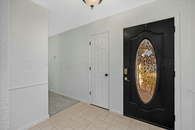 foyer featuring light colored carpet